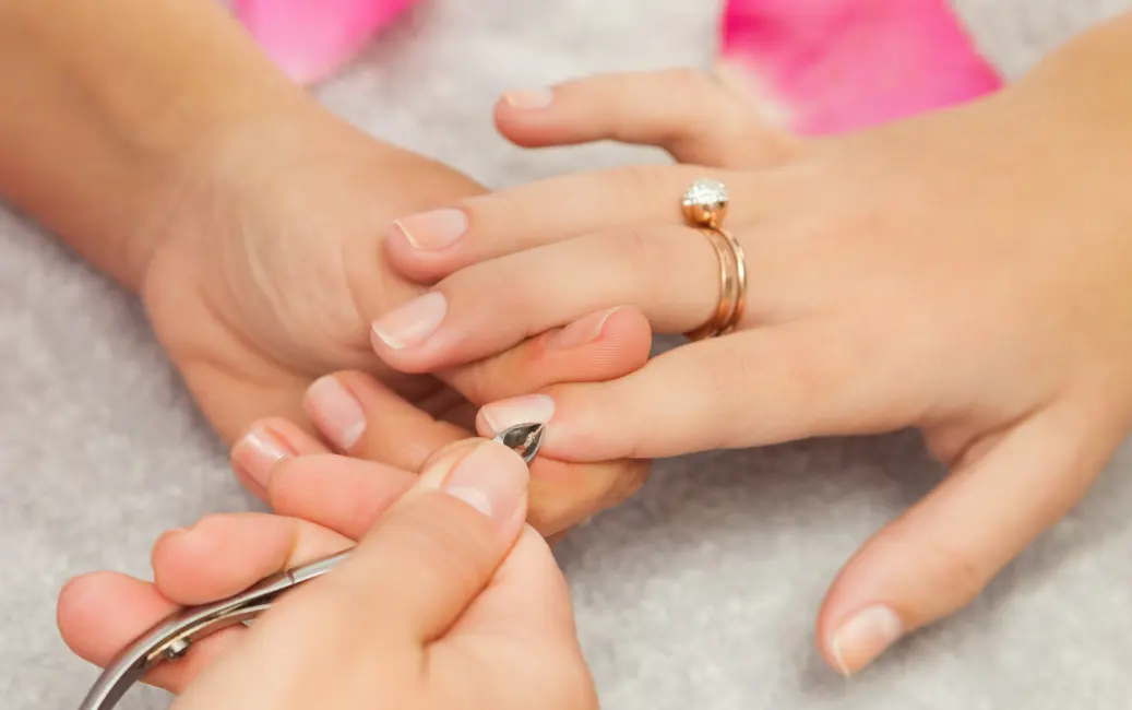 working on cuticles with nippers by another woman