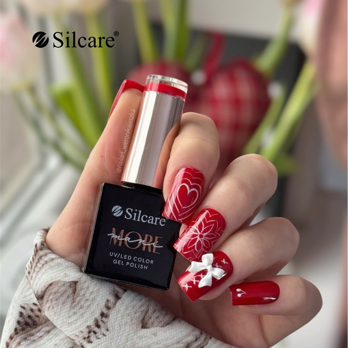 Red manicure with a bow - a charming design for special occasions