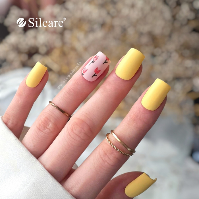 Matte yellow nails with a tulip accent
