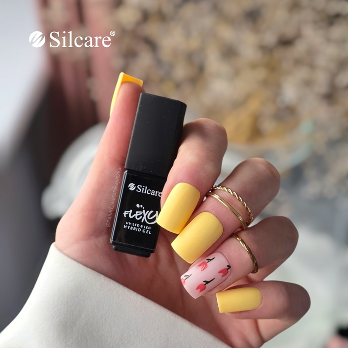 Matte yellow nails with a tulip accent